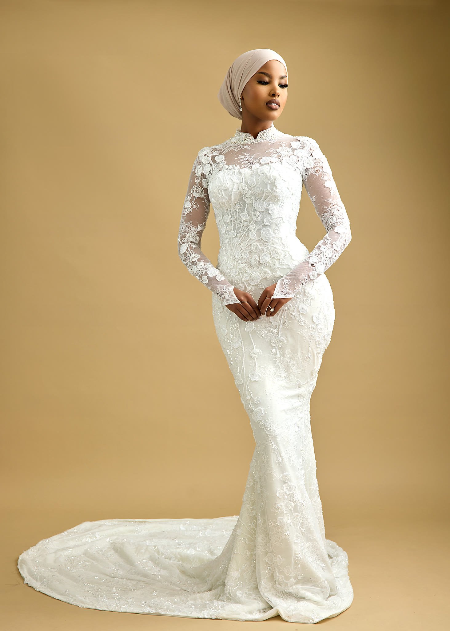 Long illusion sleeves with floral lace appliqué set over sheer tulle to the wrist