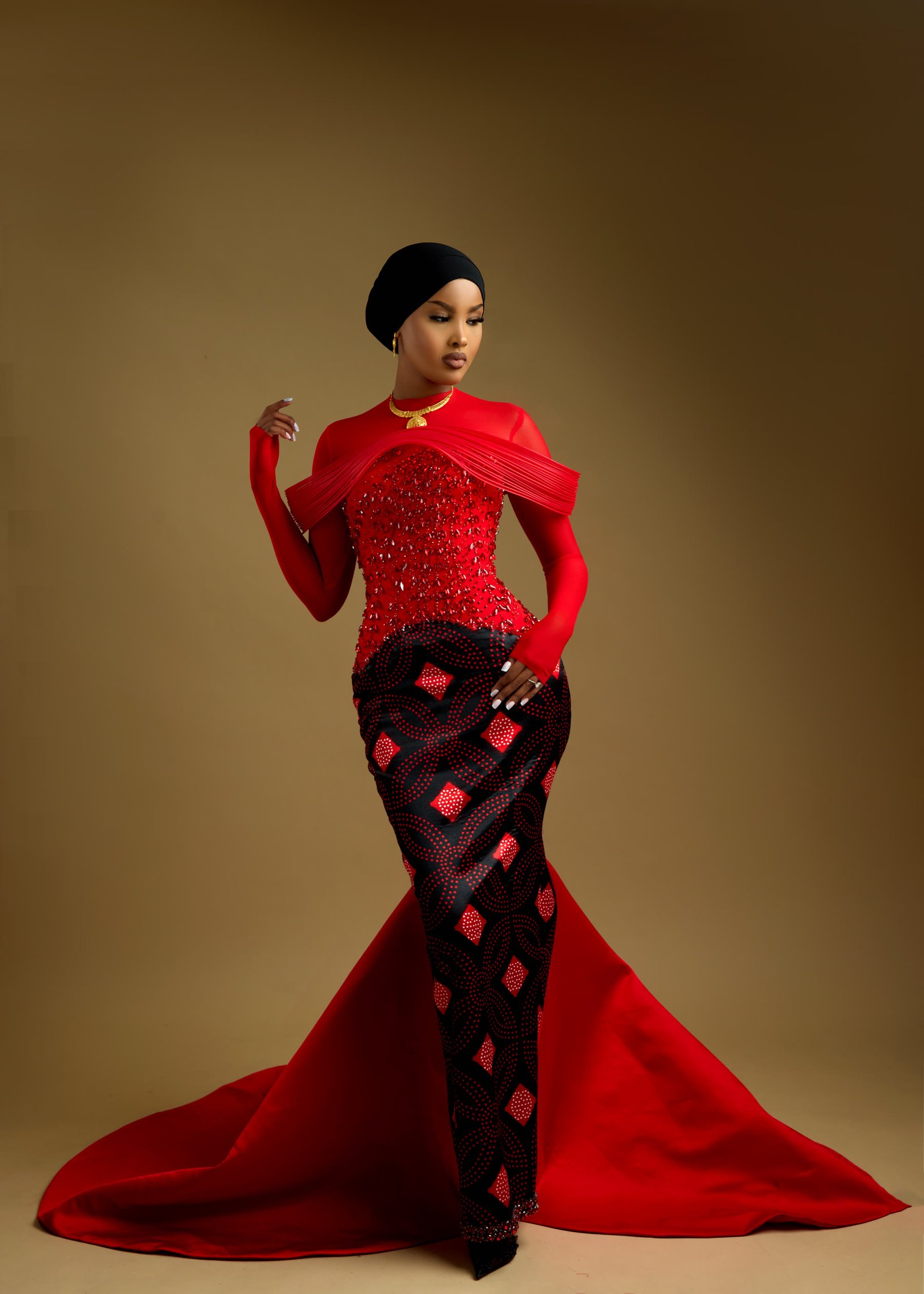 Scarlet and heritage print gown photographed mid-movement with the train sweeping out