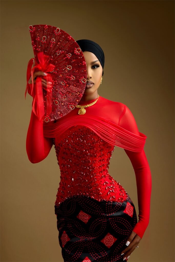 ANSSA couture gown in scarlet with hand-beaded bodice and sculpted sleeves