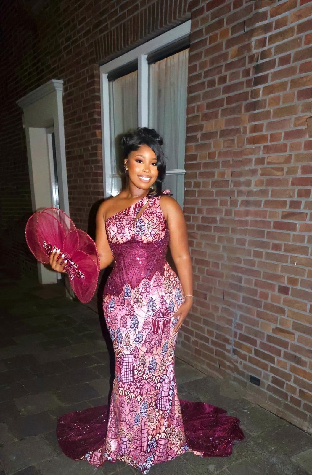 Traditional couture gown in rose heritage lace with a beaded bodice, worn with a matching feather fan